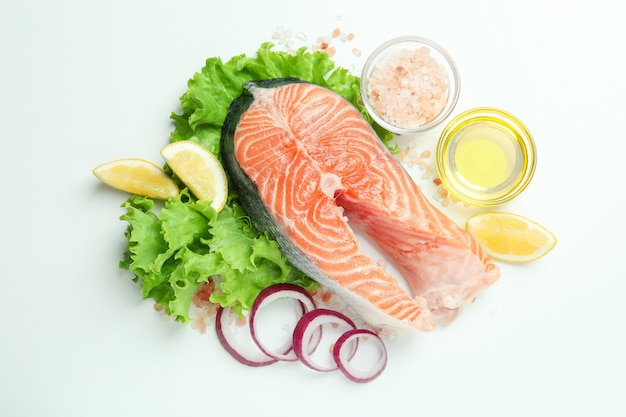 Concept of cooking salmon on white surface