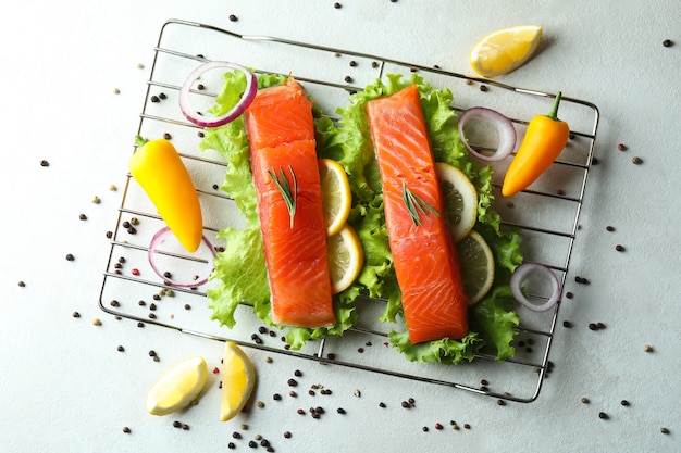 Concept of cooking salmon on white textured background