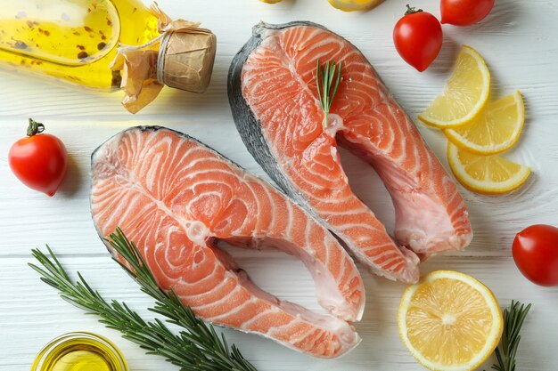 Concept of cooking salmon on white wooden table