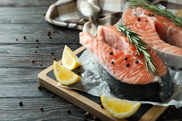 Concept of cooking salmon on wooden table