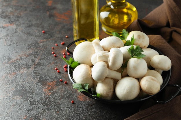 Concept of cooking with champignon on dark textured background