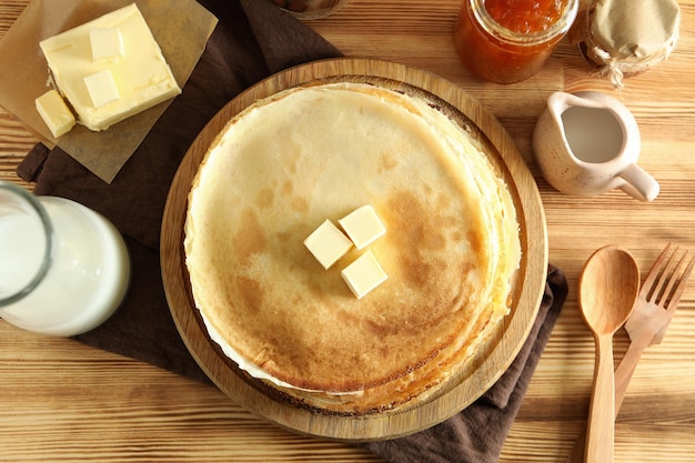 Concept of cooking with crepes on wooden table