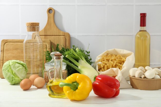 Concept of cooking with different food on white wooden table