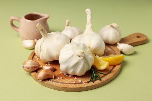 Concept of cooking with garlic on green background