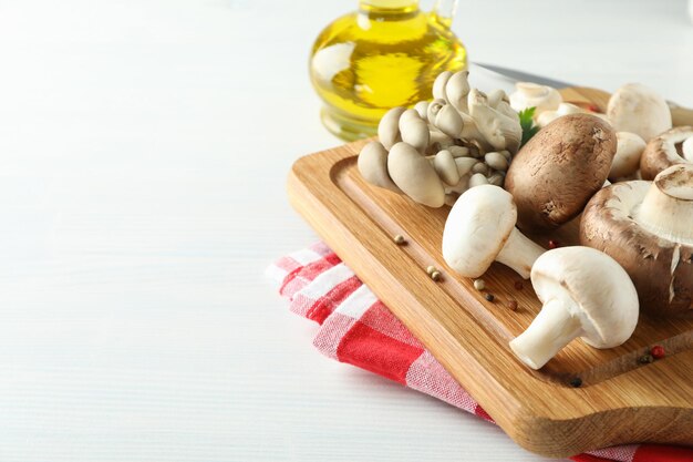 Concept of cooking with mushroom on white wooden