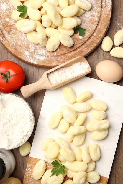 Concept of cooking with potato gnocchi on wooden background