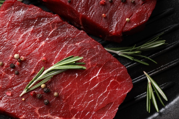 Concept of cooking with raw beef steaks, close up