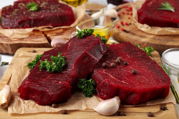 Concept of cooking with raw beef steaks, close up