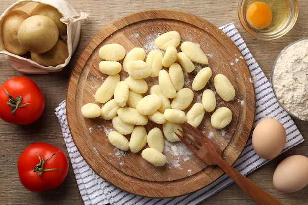 Concept of cooking with raw potato gnocchi, top view