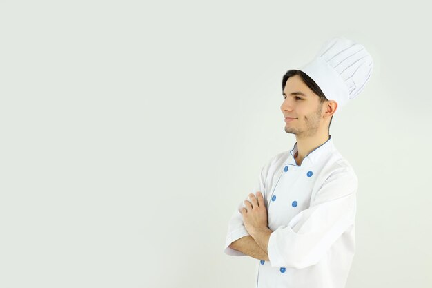 Concept of cooking young male chef on light background