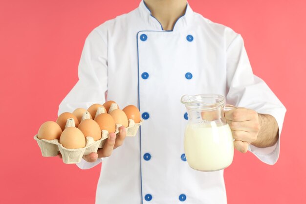 Concept of cooking young male chef with milk and eggs