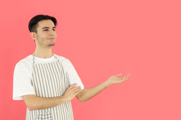 Concept of cooking young man chef on pink background