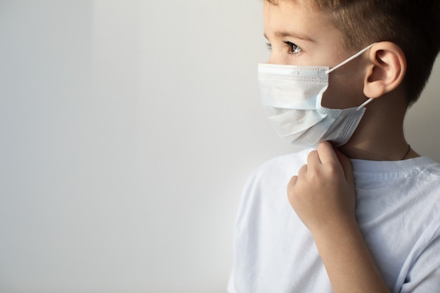 Concept of coronavirus quarantine. MERS-Cov, Novel coronavirus (2019-nCoV), boy with medical face mask. Health and medicine.