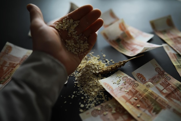 The concept of the cost of grain 5000 ruble banknotes around a
handful of ground grain world hunger