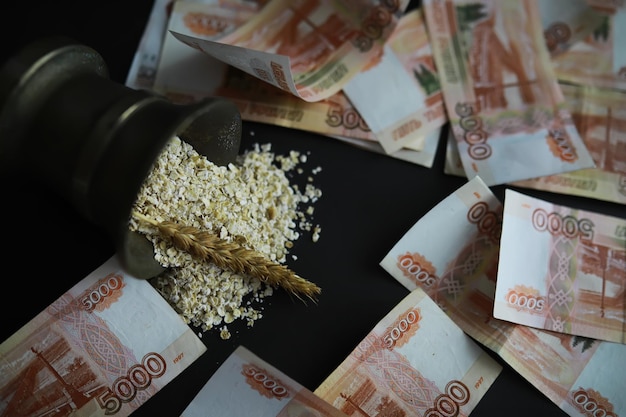 The concept of the cost of grain 5000 ruble banknotes around a handful of ground grain World hunger