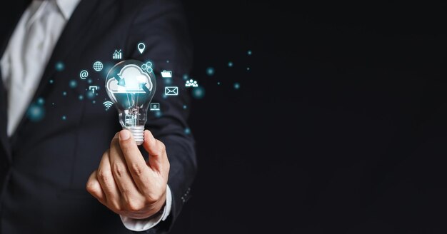 Concept of data cloud computing businessman holding light bulbs\
creative innovation connect devices information technology server\
innovation virtual power vision and security data storage