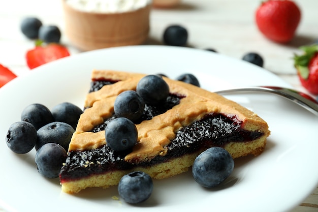 Concept of delicious dessert with blueberry pie, close up