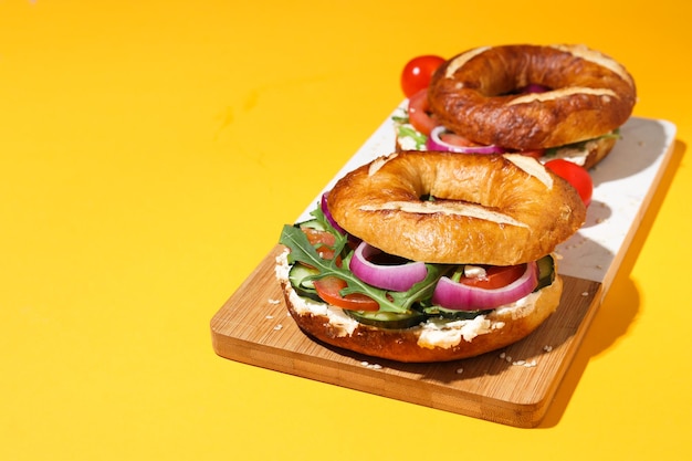 Concept of delicious food tasty bagel sandwich space for text