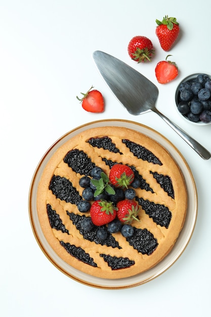 Concept of delicious food with blueberry pie on white