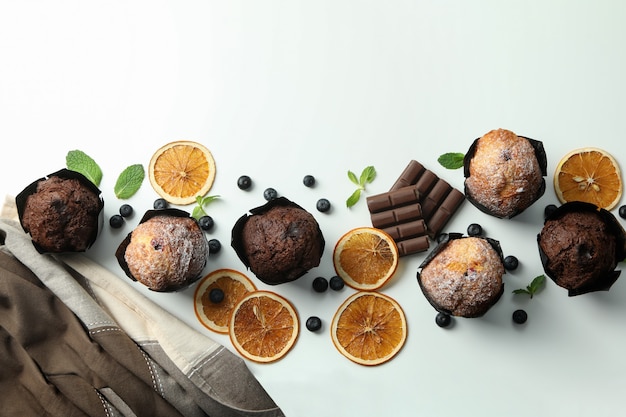 Concept of delicious food with chocolate muffins on white background.