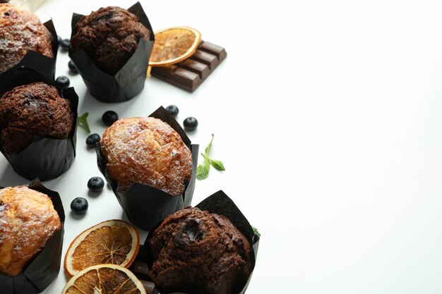 Concept of delicious food with chocolate muffins on white background.