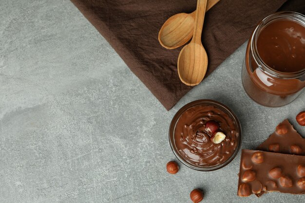 Concept of delicious food with chocolate paste on gray textured table