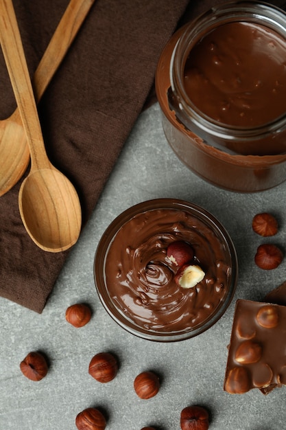 Concept of delicious food with chocolate paste on gray textured table