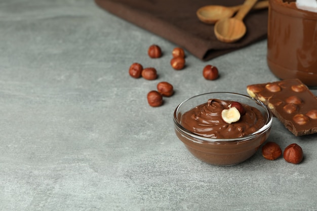 Concept of delicious food with chocolate paste on gray textured table