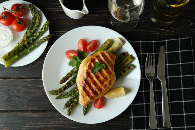 Concept of delicious food with grilled chicken meat on wooden table