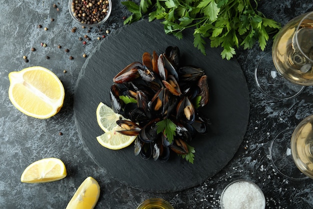 Concept of delicious food with mussels on black smokey table