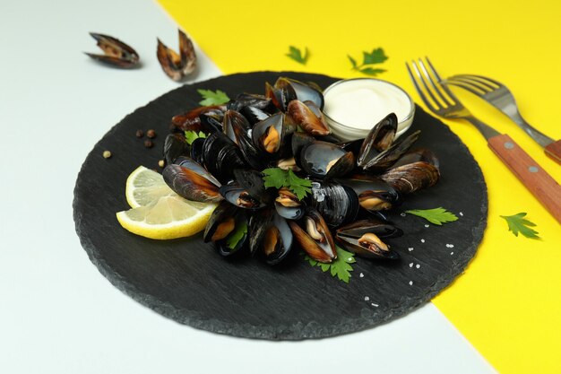 Concept of delicious food with mussels on two tone background