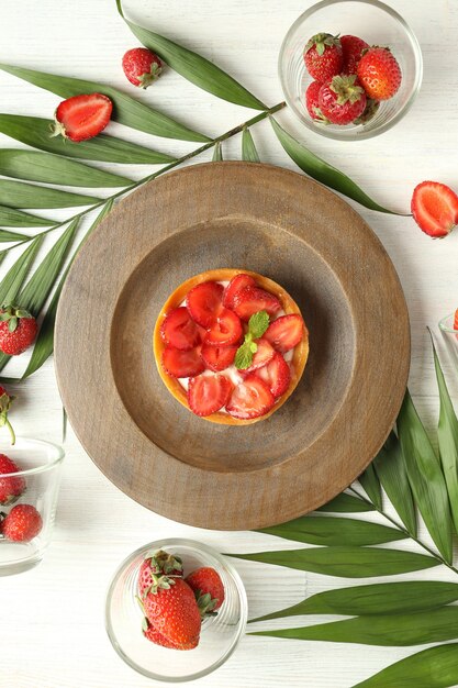 Concept of delicious food with strawberry tart, top view.