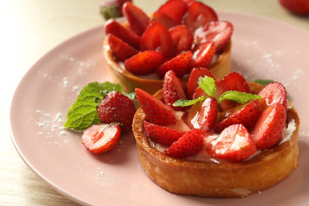 Concept of delicious food with strawberry tarts, close up.