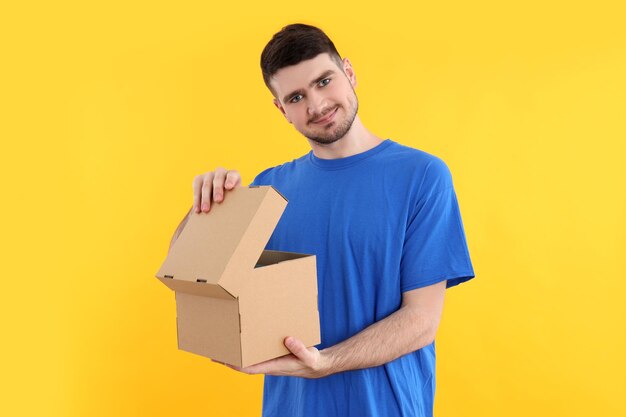 Concept of delivery surprise gift young man opened a cardboard box