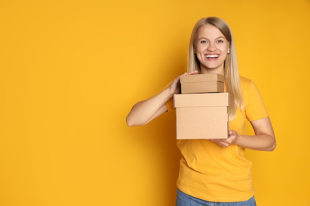 Concept of delivery surprise gift young woman and cardboard boxes