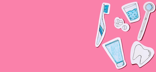 The concept of dentistry Oral care tools cut out of paper on a pink background Dental background