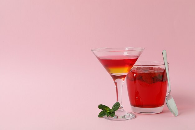 Concept of dessert with red jelly on pink background