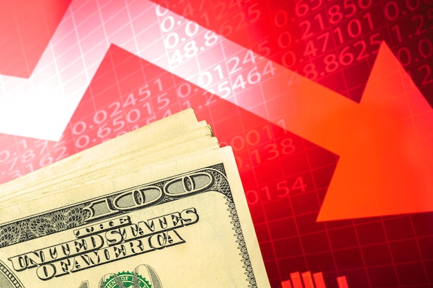 Concept of devaluation, collapse, stagnation of the economy, US dollar currency on a red stock chart graphs with arrows down