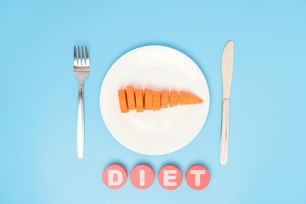 The concept of diet and raw food Raw carrots on a white plate