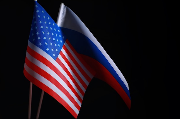 The concept of diplomatic relations. Flag of the United States of America and Russian Federation. Sanctions pressure in politics.