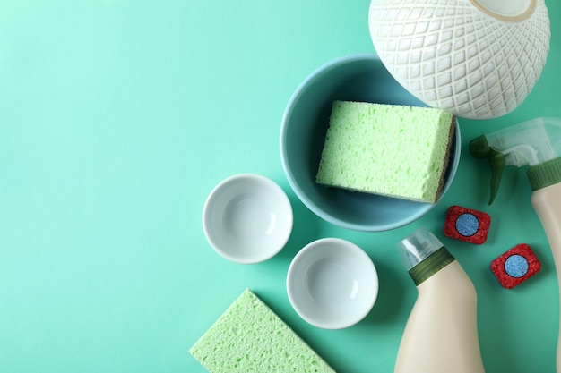 Concept of Dishwashing detergent accessories on mint background