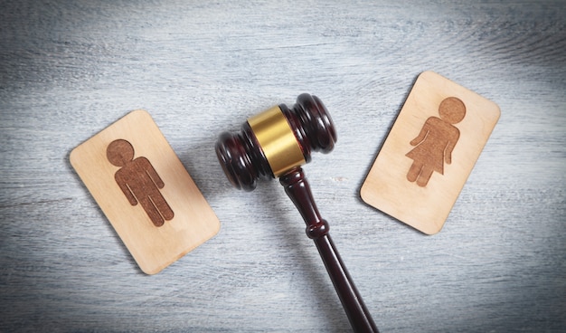 Concept of divorce. Male and female wooden symbols and judge gavel