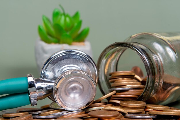 The concept of economy and medicine costs health Pile of real coins and stethoscope