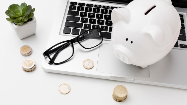 Photo concept of economy with piggy bank on laptop