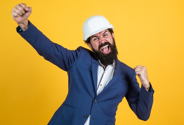 Photo concept of engineering architecture and building male builder wearing formal suit and helmet for protection working on construction project happy man with beard wear hard hat