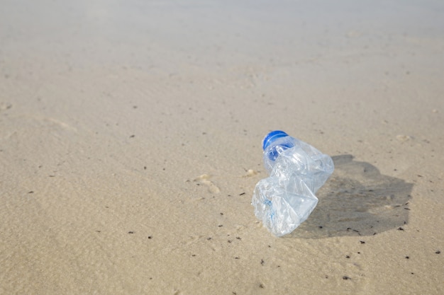 Concept for environmental campaign.Plastic bottle at the beach.