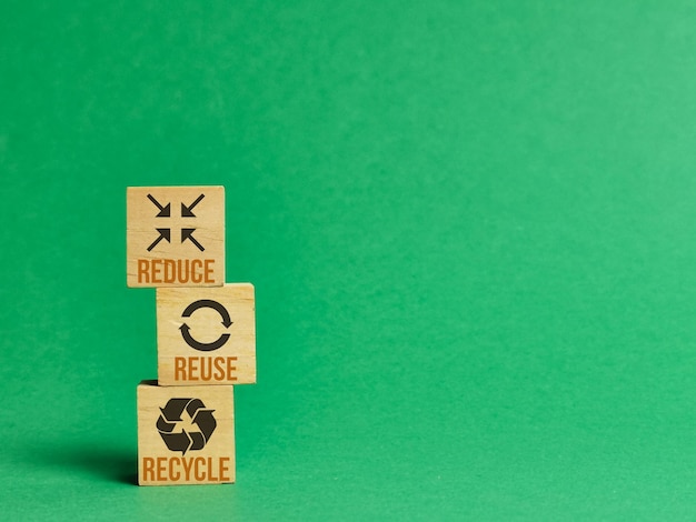 Concept of environmental conservation. Reduce, reuse and recycle symbols on wood cubes.