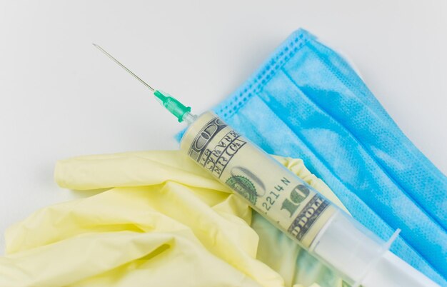 The concept of expensive corrupt medicine Medical gloves syringe with money on a white background