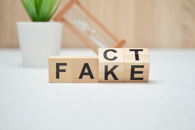 Concept of fact and fake on wooden cubes.