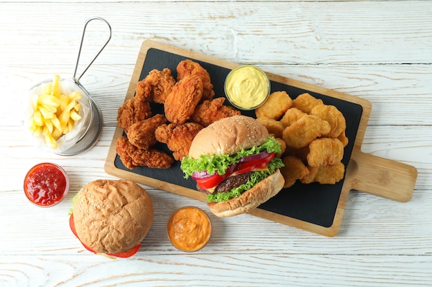 Concept of fast food on white wooden table